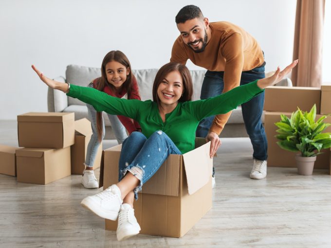 Happy family celebrating moving day in new apartment